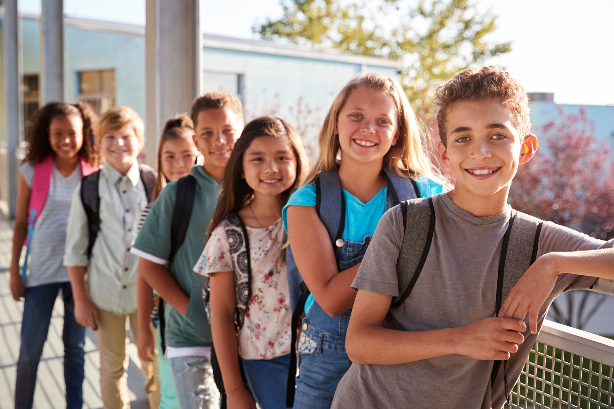 Elementary School Kids with Backpacks Smiling to the Camera